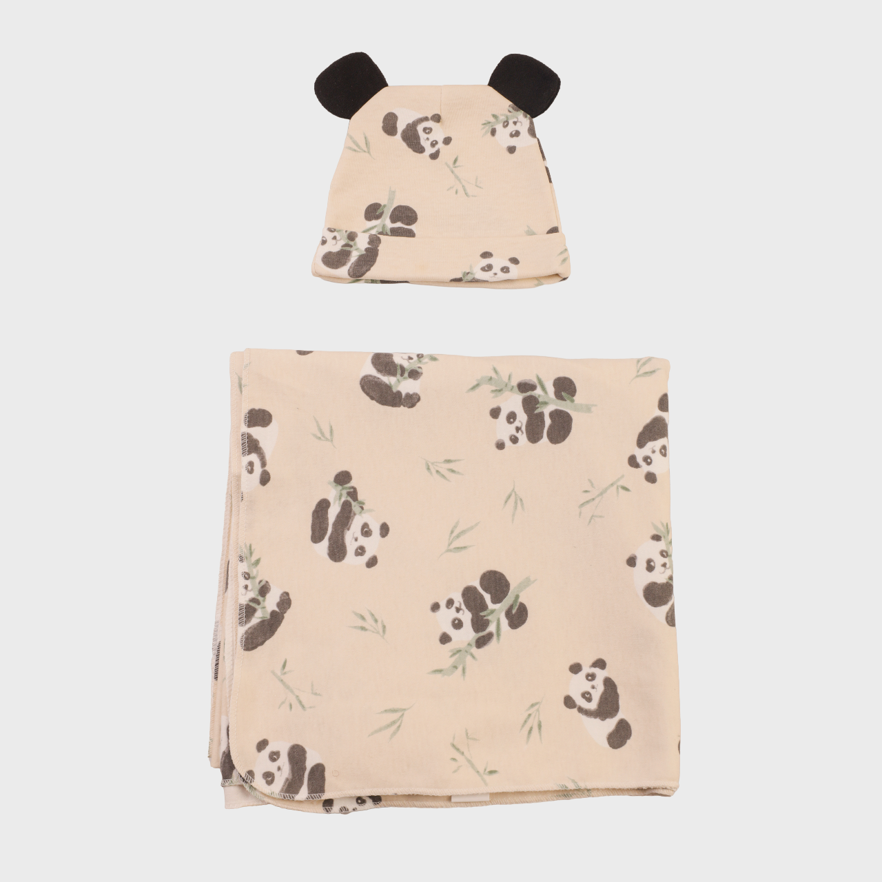 Shows blanket folded up with the hat. Depicts the cute panda design.